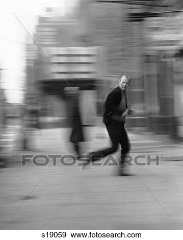 1970S Blur Motion Man Running Down City Street Looking Over His Shoulder Fear Crime View Large Photo Image Stock Photo - 1970S Blur Motion Man Running Down City Street Looking Over His Shoulder Fear Crime . Fotosearch