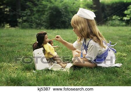 1970S Little Girl In Nurse Outfit Taking Temperature Of Doll Playing Role Practice Lawn Yard View Large Photo Image Stock Photo - 1970S Little Girl In Nurse Outfit Taking Temperature Of Doll Playing Role Practice Lawn Yard . Fotosearch