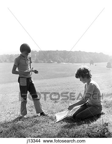 1970S Two Early Teenage Boys With Kite In Field View Large Photo Image Picture - 1970S Two Early Teenage Boys With Kite In Field. Fotosearch