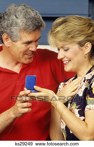 1980S 1990S Husband Giving Jewelry Gift To Wife View Large Photo Image Stock Photo - 1980S 1990S Husband Giving Jewelry Gift To Wife . Fotosearch
