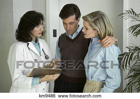 1980S Couple Consulting With Woman Doctor View Large Photo Image Stock Photograph - 1980S Couple Consulting With Woman Doctor . Fotosearch