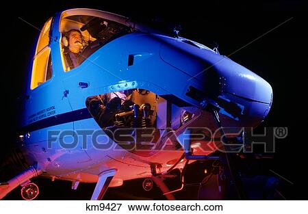 Stock Photo - 1980S Hospital Emergency Helicopter Preparing For Nighttime Mission . Fotosearch