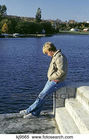 1980S Introspective Teenage Boy Sitting By Water View Large Photo Image Stock Photography - 1980S Introspective Teenage Boy Sitting By Water . Fotosearch