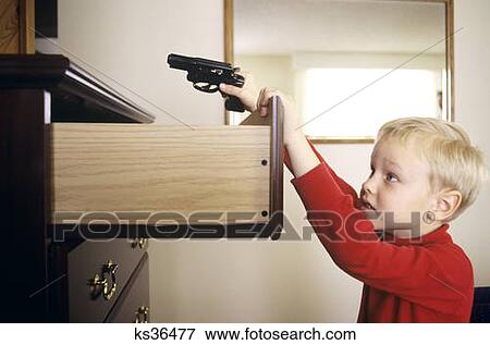 1980S Little Boy Finding Gun In Dresser Drawer View Large Photo Image Stock Photo - 1980S Little Boy Finding Gun In Dresser Drawer. Fotosearch