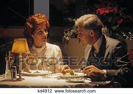 Stock Image - 1980S Middle Aged Couple Dining Romantic Restaurant. Fotosearch