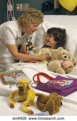 Stock Photo - 1980S Nurse With Young Patient In Hospital Bed . Fotosearch