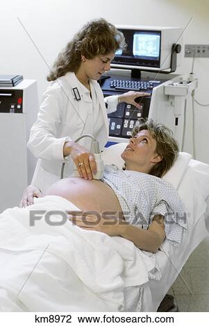 1980S Pregnant Woman Undergoing Ultrasound Exam In Hospital View Large Photo Image Stock Image - 1980S Pregnant Woman Undergoing Ultrasound Exam In Hospital . Fotosearch