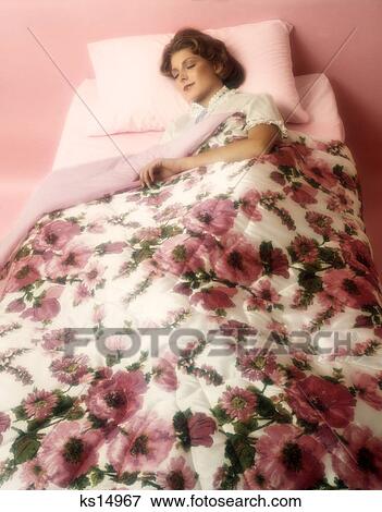 Stock Photo - 1980S Woman Sleeping In Bed With Pink Floral Blanket . Fotosearch
