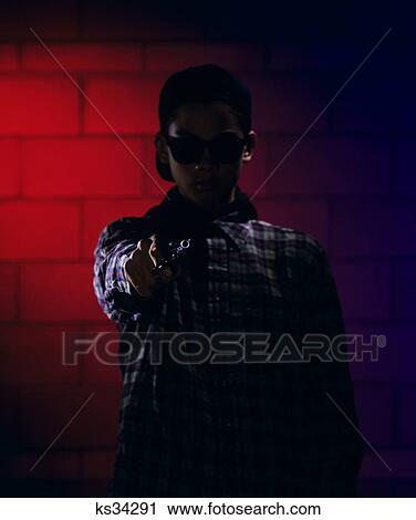 1990S Anonymous Teen Boy With Handgun Pointed At Camera View Large Photo Image Stock Image - 1990S Anonymous Teen Boy With Handgun Pointed At Camera. Fotosearch