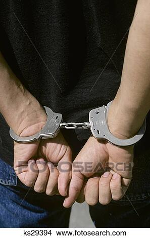 1990S Close-Up Of Anonymous Male Hands In Handcuffs View Large Photo Image Picture - 1990S Close-Up Of Anonymous Male Hands In Handcuffs. Fotosearch
