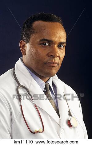 Stock Image - 1990S Doctor With Stethoscope Around His Neck . Fotosearch