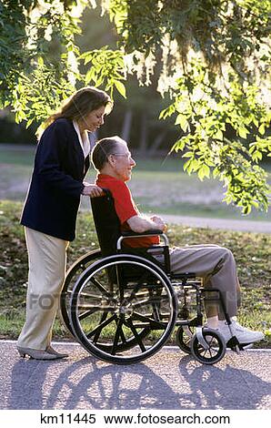 1990S Female Nurse Pushing Senior Man In Wheelchair Outdoors View Large Photo Image Stock Photography - 1990S Female Nurse Pushing Senior Man In Wheelchair Outdoors . Fotosearch