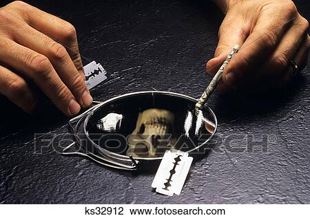 1990S Hands Holding A Razor Blade And A Rolled Up $20. 00 Bill Over Mirror Covered With Cocaine With Reflection Of A Skull View Large Photo Image Stock Image - 1990S Hands Holding A Razor Blade And A Rolled Up $20. 00 Bill Over Mirror Covered With Cocaine With Reflection Of A Skull . Fotosearch