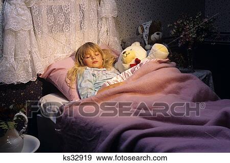 Stock Photo - 1990S Little Girl Asleep In Bed With Stuffed Animals . Fotosearch