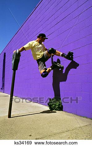 1990S Man With Roller Blades Jumping Against Purple Wall View Large Photo Image Stock Photo - 1990S Man With Roller Blades Jumping Against Purple Wall . Fotosearch