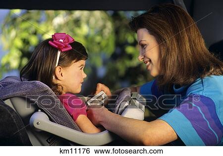 1990S Mother Putting Daughter In Carseat View Large Photo Image Stock Photograph - 1990S Mother Putting Daughter In Carseat . Fotosearch