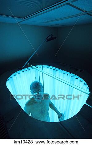 Stock Photo - 1990S Patient In Uv Light Booth Used To Activate Drugs To Fight Mycosis Fungoides Cancer . Fotosearch