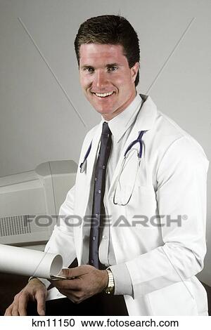 Stock Image - 1990S Portrait Of Young Doctor Smiling Looking At Camera. Fotosearch