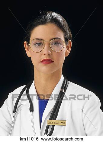 Stock Photograph - 1990S Portrait Woman Doctor Wearing Eyegalasses Looking At Camera. Fotosearch