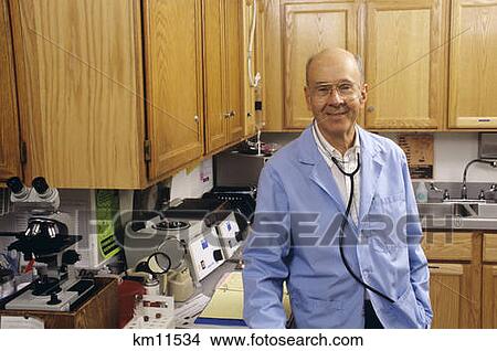 1990S Smiling Senior Pediatrician Standing In A Lab Looking At Camera View Large Photo Image Picture - 1990S Smiling Senior Pediatrician Standing In A Lab Looking At Camera . Fotosearch