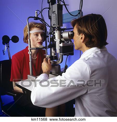 1990S Woman Receiving Eye Exam Looking Through Phoropter View Large Photo Image Stock Photo - 1990S Woman Receiving Eye Exam Looking Through Phoropter. Fotosearch