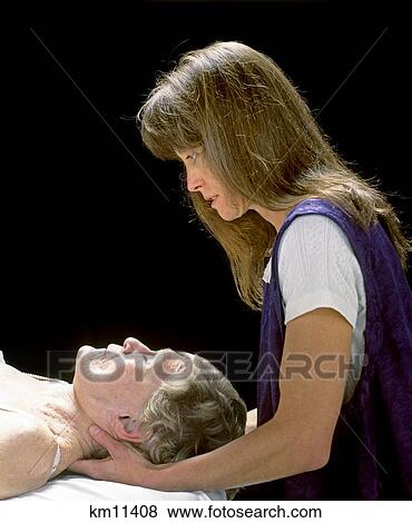 Stock Photo - 1990S Woman Supporting Head Of Elderly Woman In Her Hand . Fotosearch