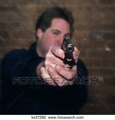 1990S Young Man Looking At Camera And Pointing Gun View Large Photo Image Stock Image - 1990S Young Man Looking At Camera And Pointing Gun. Fotosearch