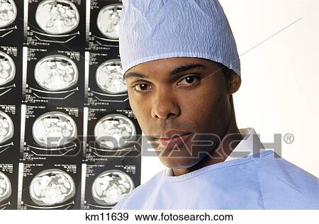 2000S Portrait Of African American Doctor Wearing Scrubs Looking At Camera With Body Scans In Background View Large Photo Image Stock Photo - 2000S Portrait Of African American Doctor Wearing Scrubs Looking At Camera With Body Scans In Background. Fotosearch