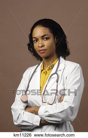 African American Female Doctor Serious Facial Expression Looking At Camera View Large Photo Image Stock Photograph - African American Female Doctor Serious Facial Expression Looking At Camera. Fotosearch