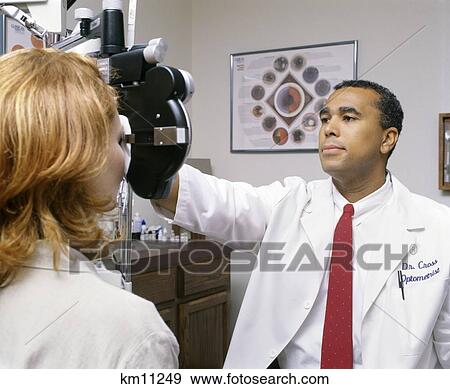 examining optometrist phoropter fotosearch