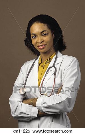 Stock Photography - African American Woman Physician Looking At Camera With Stethoscope Around Neck. Fotosearch