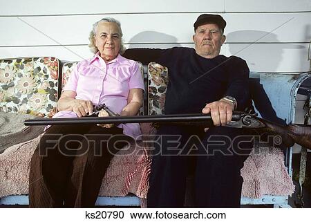 Elderly Couple With Shotgun & Pistol Sitting On Porch Glider View Large Photo Image Stock Image - Elderly Couple With Shotgun & Pistol Sitting On Porch Glider. Fotosearch