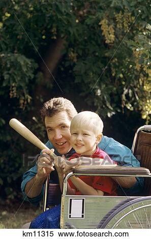 Stock Photography - Father Teaching Son To Play Baseball Son In Wheelchair . Fotosearch