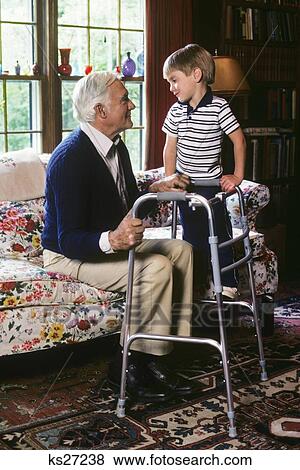 Grandfather With Walker And Grandson On Couch View Large Photo Image Stock Photo - Grandfather With Walker And Grandson On Couch. Fotosearch