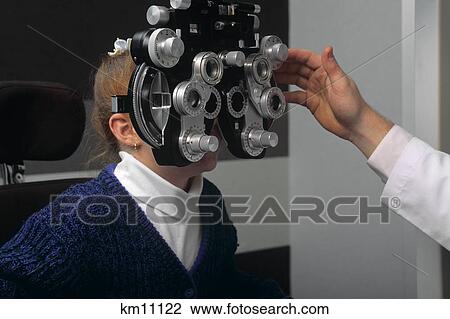 Little Girl Undergoing Eye Examination Looking Into Phoropter View Large Photo Image Stock Image - Little Girl Undergoing Eye Examination Looking Into Phoropter. Fotosearch