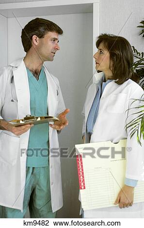 Man And Woman Doctors Having Discussion View Large Photo Image Stock Image - Man And Woman Doctors Having Discussion . Fotosearch