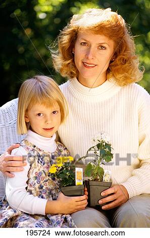 Mother And Child Sitting In Wicker Chair Holding Flower Pots View Large Photo Image Picture - Mother And Child Sitting In Wicker Chair Holding Flower Pots . Fotosearch