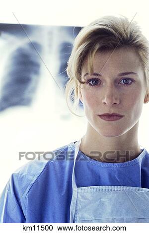 Portrait Of Female Doctor Wearing Scrubs Looking At Camera X-Ray In Background View Large Photo Image Stock Image - Portrait Of Female Doctor Wearing Scrubs Looking At Camera X-Ray In Background . Fotosearch