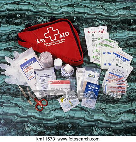 Stock Image - Red First Aid Kit With Contents Of Kit On Display. Fotosearch