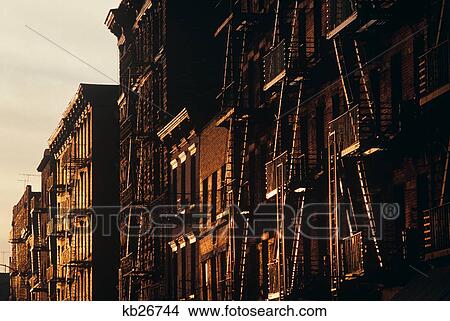 Row Of Residential Buildings With Fire Escapes In Afternoon Sun New York City View Large Photo Image Picture - Row Of Residential Buildings With Fire Escapes In Afternoon Sun New York City . Fotosearch