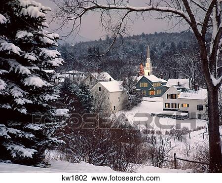 Stock Image - Snow Covered New England Winter Evening Scene With Lights On A Christmas Tree Nostalgia Whitefield Nh . Fotosearch