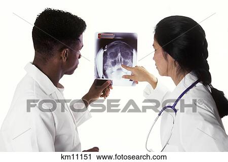 Stock Image - Two Doctors Viewing Head X-Ray . Fotosearch