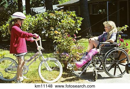 Two Girls Talking One On Bike And The Other With Leg Cast In Wheelchair View Large Photo Image Stock Photo - Two Girls Talking One On Bike And The Other With Leg Cast In Wheelchair . Fotosearch