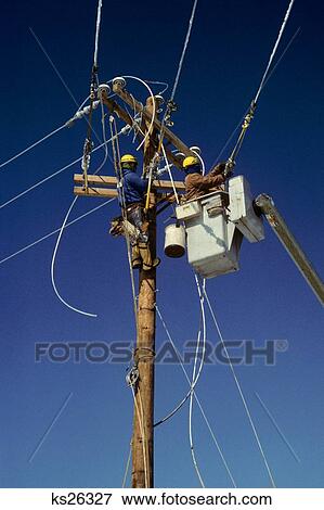 Two Telephone Linemen Working On Overhead Wires View Large Photo Image Stock Photo - Two Telephone Linemen Working On Overhead Wires. Fotosearch