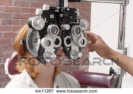 Woman Having Vision Tested With Phoropter Measuring For Lens Perscription View Large Photo Image Stock Photo - Woman Having Vision Tested With Phoropter Measuring For Lens Perscription. Fotosearch