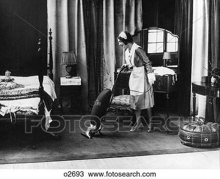 1920S Uniformed Maid Running Eureka Vacuum In Bedroom View Large Photo Image Stock Image - 1920S Uniformed Maid Running Eureka Vacuum In Bedroom. Fotosearch