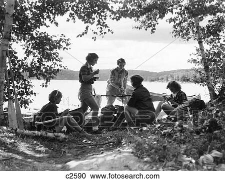 1930S 5 Girls Around Camp Fire Near Lake Canoe Summer Youth Algonquin Park Canada View Large Photo Image Stock Image - 1930S 5 Girls Around Camp Fire Near Lake Canoe Summer Youth Algonquin Park Canada . Fotosearch