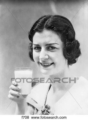 1930S Brunette Woman Smiling Holding A Glass Of Milk Looking At Camera View Large Photo Image Stock Photo - 1930S Brunette Woman Smiling Holding A Glass Of Milk Looking At Camera. Fotosearch