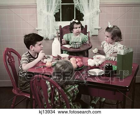 1940S 1950S Boy And Girls Eating Breakfast At Kitchen Table Food Cereal Bread Milk Eggs Apples View Large Photo Image Picture - 1940S 1950S Boy And Girls Eating Breakfast At Kitchen Table Food Cereal Bread Milk Eggs Apples . Fotosearch
