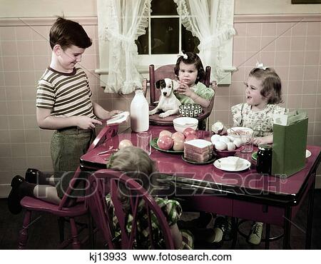 1940S 1950S Boy Making Peanut Butter Sandwich In Kitchen Three Girls And Dog Sitting High Chair Table With Food View Large Photo Image Stock Image - 1940S 1950S Boy Making Peanut Butter Sandwich In Kitchen Three Girls And Dog Sitting High Chair Table With Food . Fotosearch
